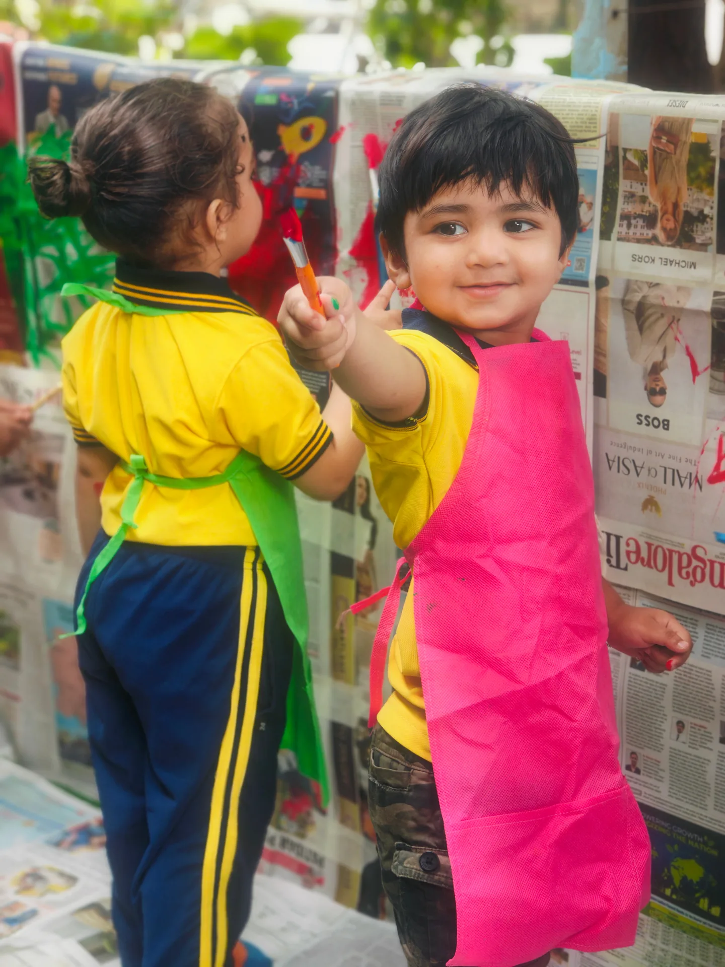 Two children painting together at an art activity