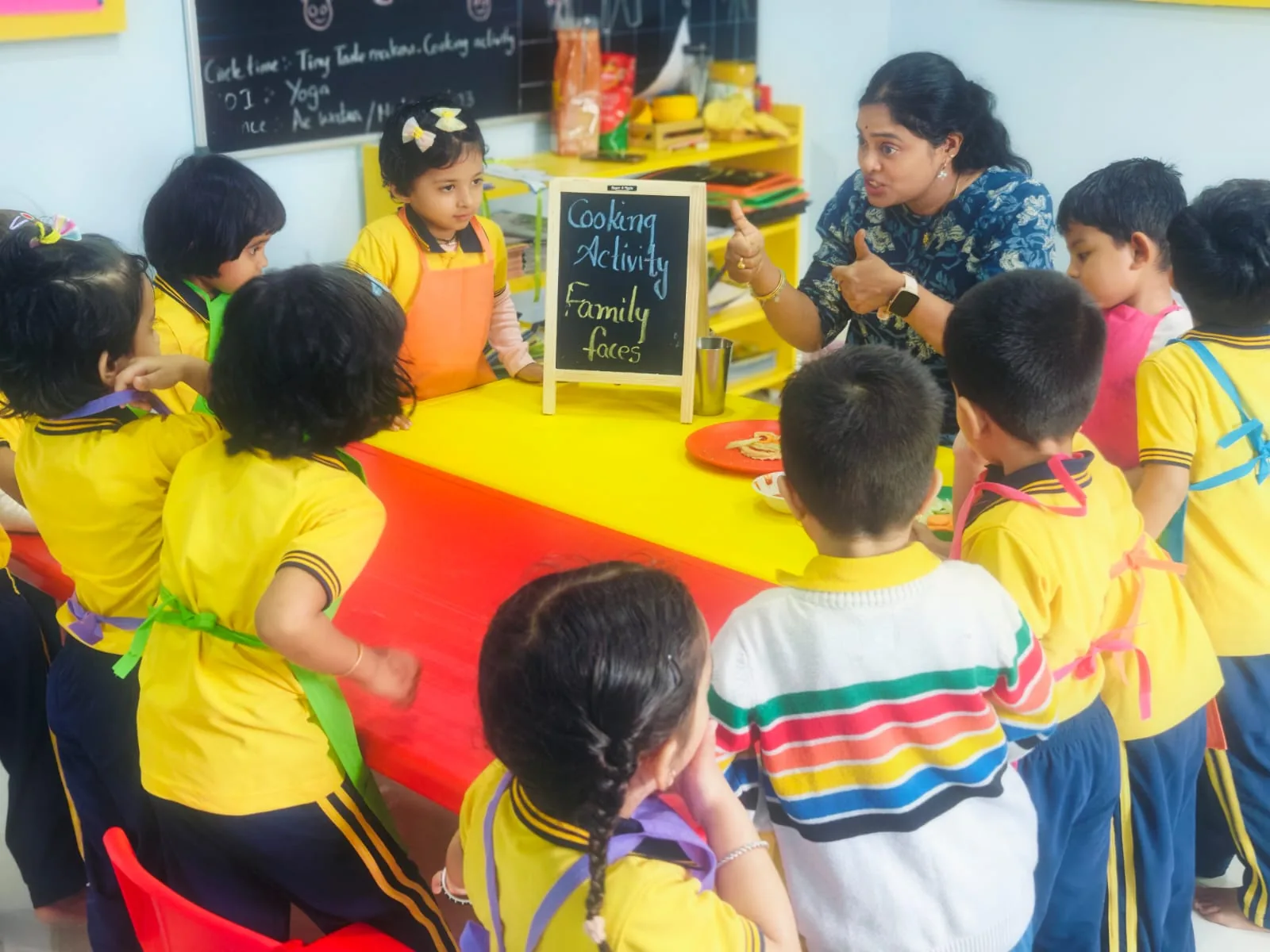 Children gathered around a cooking activity table