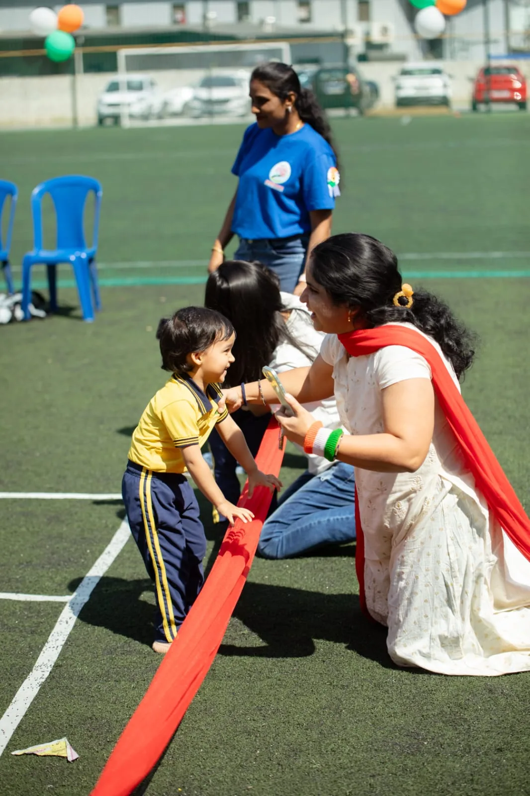 Guide cheering on a child at sports day