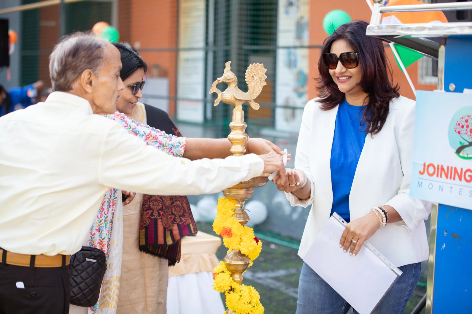 Founder of Joining Dots Montessori lighting the ceremonial lamp